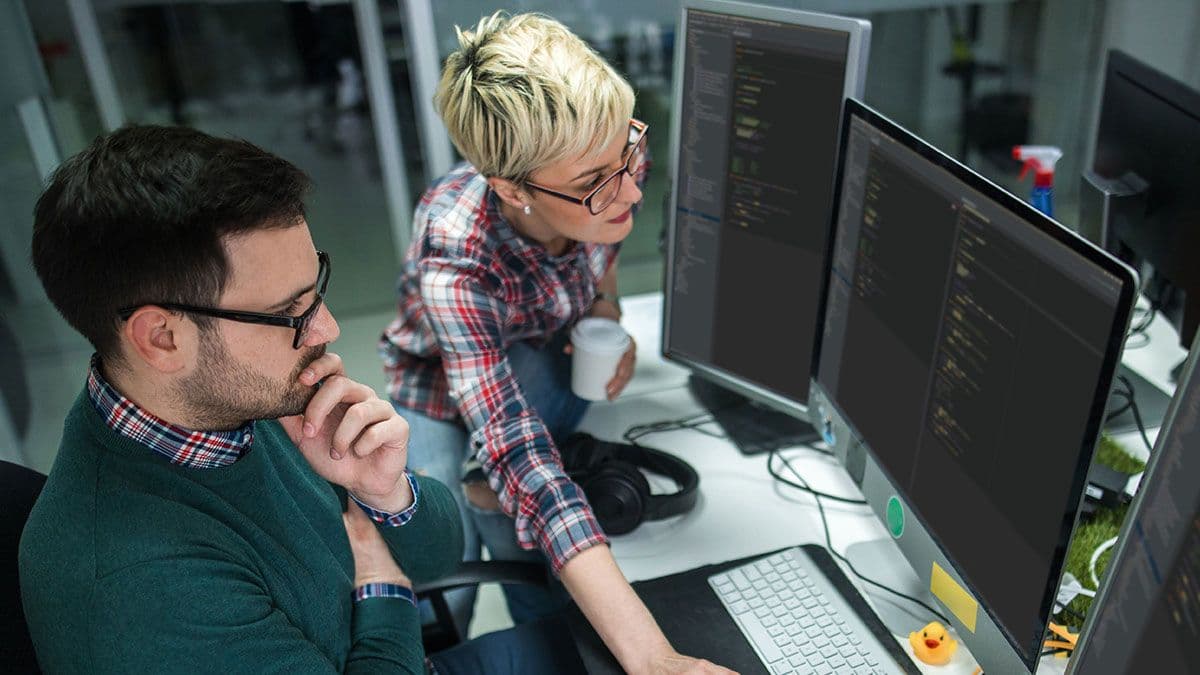 Two people looking at a computer